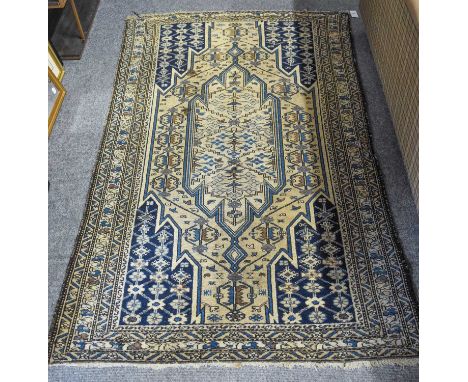 Mazlaghan Rug, the mustard field of lightning design centred by a floral medallion enclosed by multiple borders, 200cm by 130
