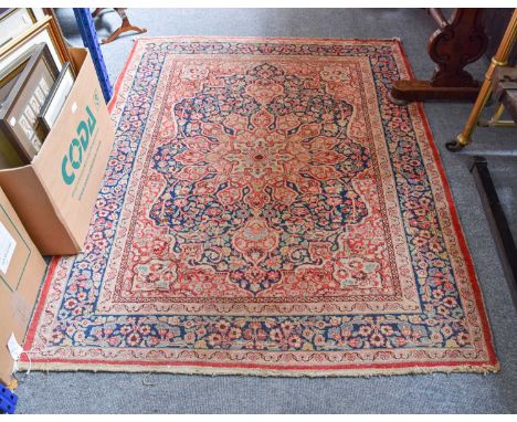 Tabriz Rug, the indigo field of flowering vines centred by a flowerhead medallion, framed by spandrels and indigo borders of 