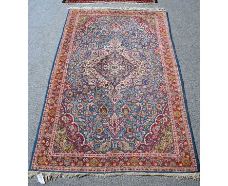 Kashan Design Rug, the field of palmettes and floral vines centred by an indigo and ivory medallion, framed by spandrels and 