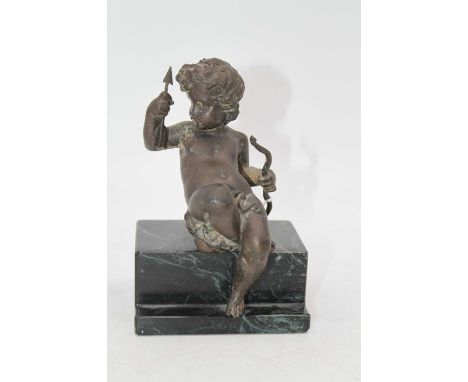 A circa 1900 French bronze figure, modelled as Cupid in seated pose with bow &amp; arrow in hand, on integral verdigris stepp