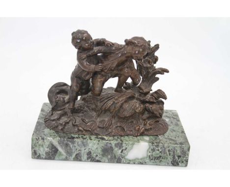 A 19th century French bronze figure group, modelled as two young children playing with a bird and dog on naturalistic base, a