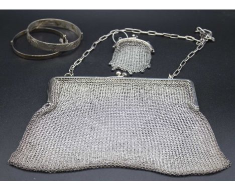 A silver hinge bangle with engraved decoration together with one other bangle, chain link miser's purse, and one other (4)