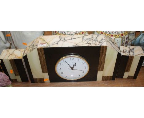 An Art Deco polished hardstone mantel clock garniture, w.46cm