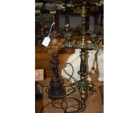 A figural resin table lamp, having a frosted glass shade, h.57cm 