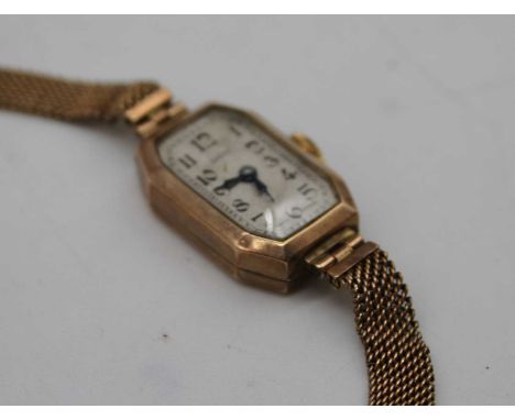 A ladies Art Deco Dot 9ct gold cased tank watch having manual wind movement and on 9ct gold mesh link bracelet, gross weight 