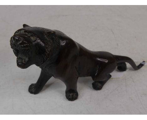 A Japanese bronze model of a tiger, length 19cmComplete.Appears to be free from breaks.Minor wear to the patina in places.Som