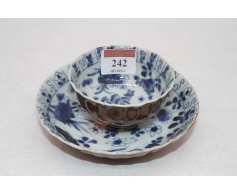 A late 18th / early 19th century Chinese tea bowl and saucer, underglaze blue decorated with flowers, saucer dia.13cmLight fr