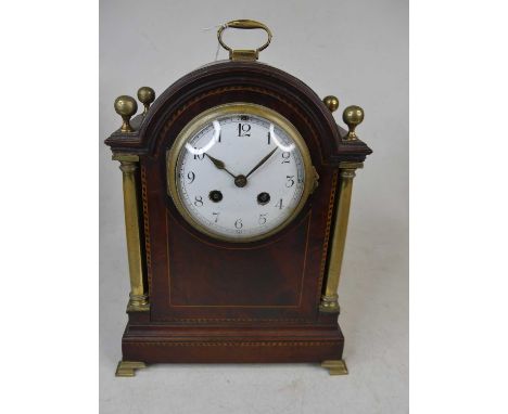 An Edwardian mahogany and barber-pole strung mantel clock, the enamelled dial showing Arabic numerals, the eight-day movement