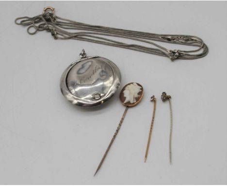 A gilt metal carved shell cameo set tie-pin; together with two paste set tie-pins; a silver small powder compact; and a steel