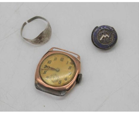 A vintage gents 9ct gold cased manual wind wrist watch together with a gents silver signet ring (cut) and an enamel badge (3)