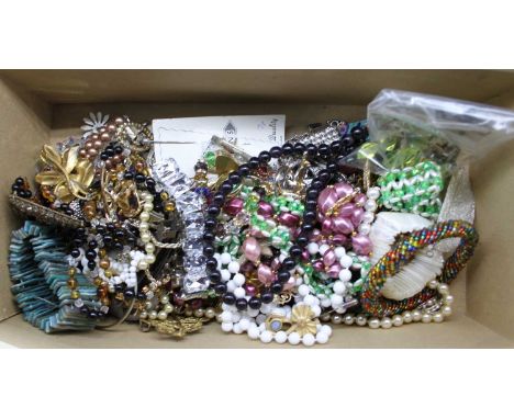 A collection of miscellaneous costume jewellery to include paste set brooches, plastic bangle, various bead necklaces etc