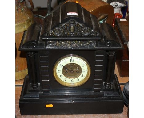A Victorian black slate mantel clock, the enamelled chapter ring showing Arabic numerals, the eight-day movement having visib