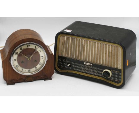 A 1950s walnut cased mantel clock, having a silvered dial with Arabic numerals, the eight-day movement striking on a gong, w.