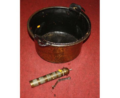 A large copper pan, dia.40cm; together with a brass grinder dated 1930