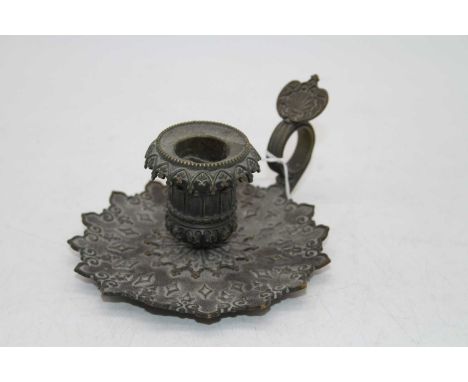 A circa 1900 French bronze chamber stick, the circular sconce on a shaped base with geometric decoration and shell cast thumb