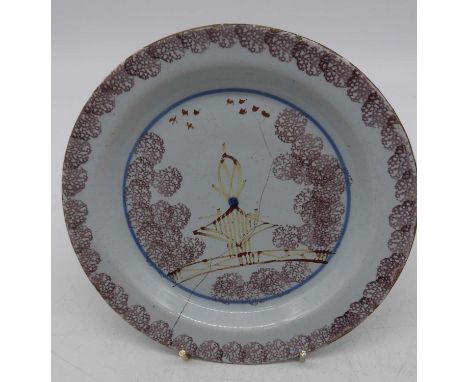 An English delftware side plate, probably Bristol, sponge decorated in manganese, dia.17cm (a/f)