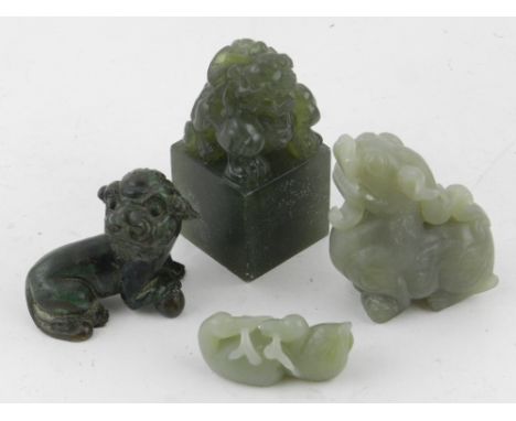 Two Chinese pale green jade carvings of Shishi and two ducks, together with a green hardstone Shishi seal and a cast iron stu