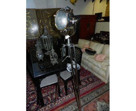 A chrome plated 'search light' standard lamp, raised on a tripod base. H: 167cm 