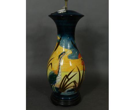 A large Moorcroft table lamp base, of baluster form and tube-lined decorated with stalk in landscape, raised on a circular wo