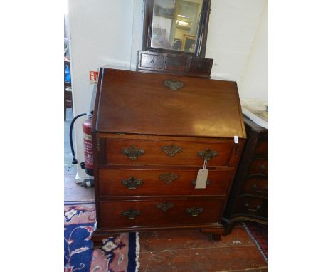 An early 20th century writing commode, having a drop down leaf with leather inlay above three long drawers. H.99cm, L.76cm