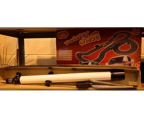 A boxed 4V Tasco telescope with tripod and a boxed Chad Valley Twister racing set. Not available for in-house P&amp;P, contac