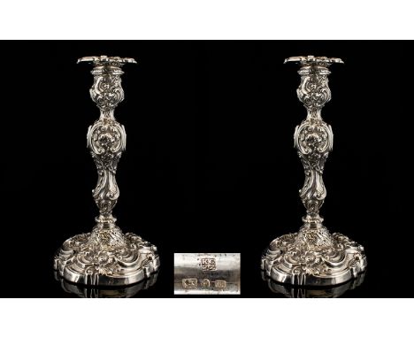George IV Superb Quality Pair of Silver Candlesticks of impressive form and proportions.  With heavy embossed decoration.  Ma