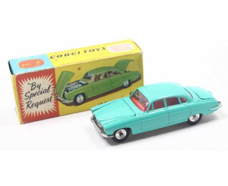 A Corgi Toys No. 238 Jaguar Mk10 comprising of pale green body with red interior and spun hubs complete with suitcase load, m