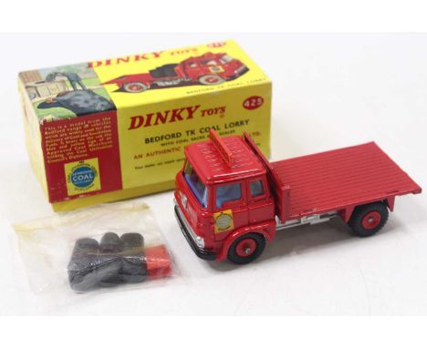 A Dinky Toys No. 425 Bedford TK Coal lorry comprising of red and silver body with red plastic hubs and blue interior with ori