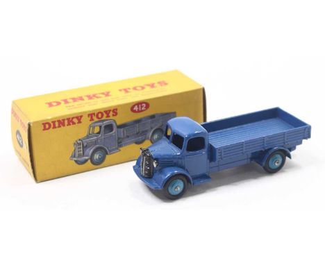 A Dinky Toys No. 412 Austin wagon comprising of dark blue cab and chassis with mid blue hubs housed in the original box (E-NM