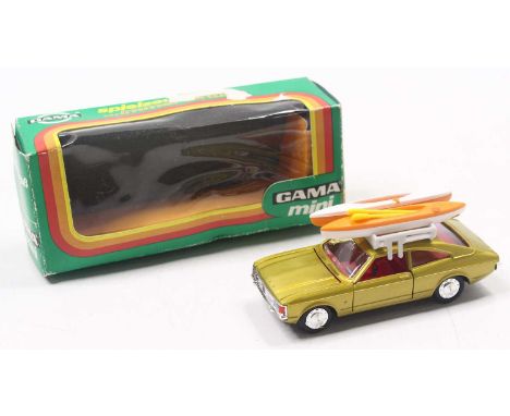 Gama No. 9961 Ford Consul GT Coupe metallic gold with tan interior, roof rack and two kayaks and two paddles, housed in the o
