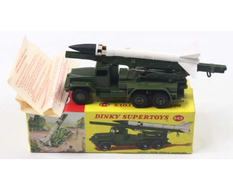 Dinky Toys, 665 Honest John Missile Launcher, green body and hub, with black and white missile, in the original picture sided