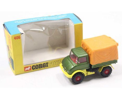 A Corgi Toys boxed No. 406 Unimog comprising metallic green and yellow body, red hubs with orange plastic rear cover in the o