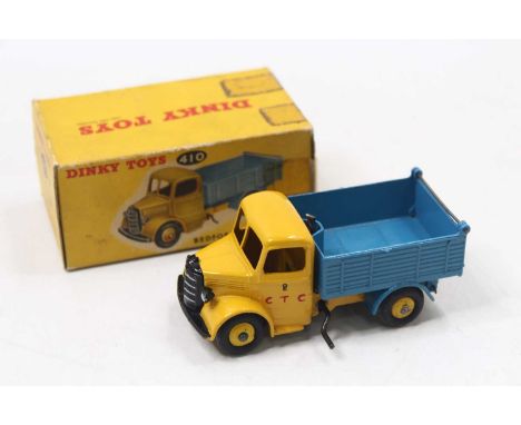 Dinky Toys No. 410 Bedford End Tipper Truck, yellow cab and chassis with yellow hubs and blue back, in the original all card 