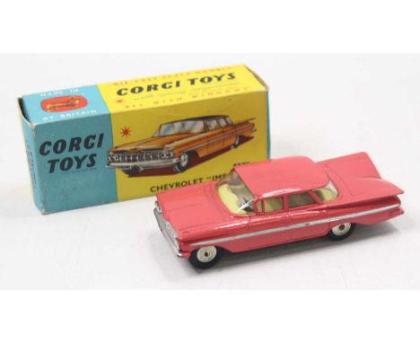Corgi Toys No. 220 Chevrolet Impala comprising pink body with yellow interior and spun hubs, housed in the original blue &amp
