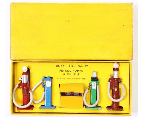 Dinky Toys, No.049 Petrol Pump Set, post-war example, comprising 4 petrol pumps and oil bin, housed in the yellow ground card