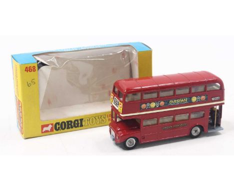 Corgi Toys No. 468 London Routemaster Bus comprising red body, off-white interior, silver cast work hubs with Outspan livery,