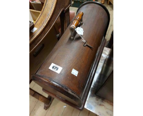 An old twin bobbin sewing machine in wooden dome top case