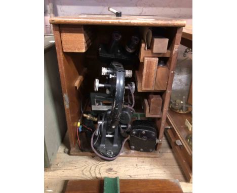 A vintage Cooke, Troughten &amp; Simms Ltd. binocular microscope in original fitted wooden box with accessories - sold with a