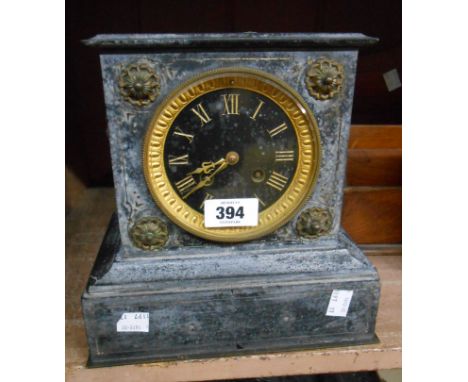 A late Victorian black slate cased mantel clock with flanking lion mask ring handles and Japy Freres eight day bell striking 