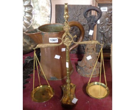 A small selection of assorted metalware comprising large copper jug, Victorian cast iron doorstop and set of brass balance sc