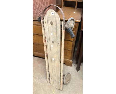 A vintage Flexi-Racer (Model No. 300) wheeled sled with slatted top and handle bar steering (damper springs missing), by S.L.