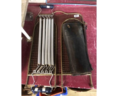 A vintage spring chest expander, a pair of old black leather gaiters marked for Manfield's 'Colonial' legging and an old bras
