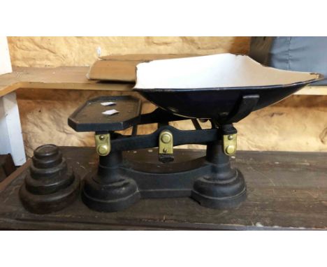 An old set of cast iron scales and weights with enamel pan