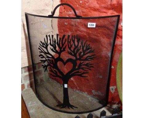 A modern wrought iron and mesh firescreen with tree and heart motif to front
