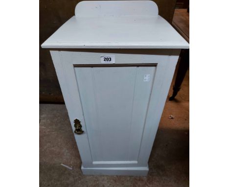 A light grey painted wood pot cupboard enclosed by a panelled door