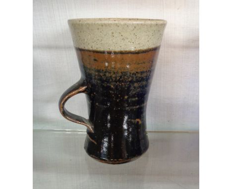 A Leach studio pottery St. Ives mug of tall form with loop handle and impressed seal mark to base