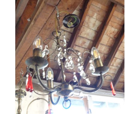 A modern three branch hanging electric chandelier with clear and red glass coloured drops