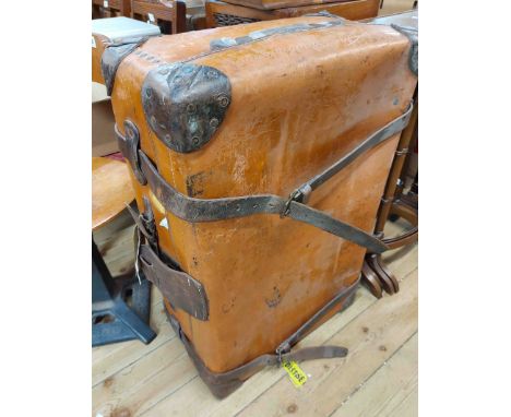 A vintage fibreboard suitcase with leather bound corners and straps and tray fitted interior