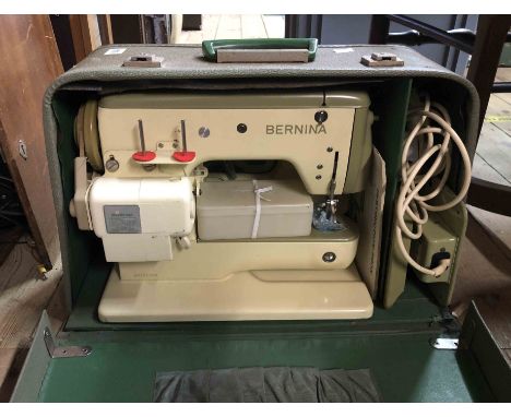 A vintage Singer electric sewing machine Model 347 with light green paint finish in original green carry case - sold with an 