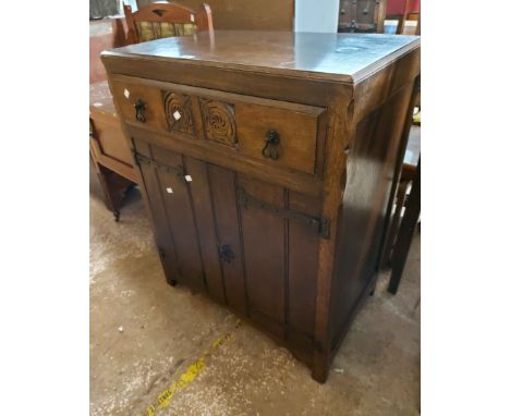 A 76cm vintage oak cabinet in the Old Charm style with carved decoration to single frieze drawer and double cupboard under